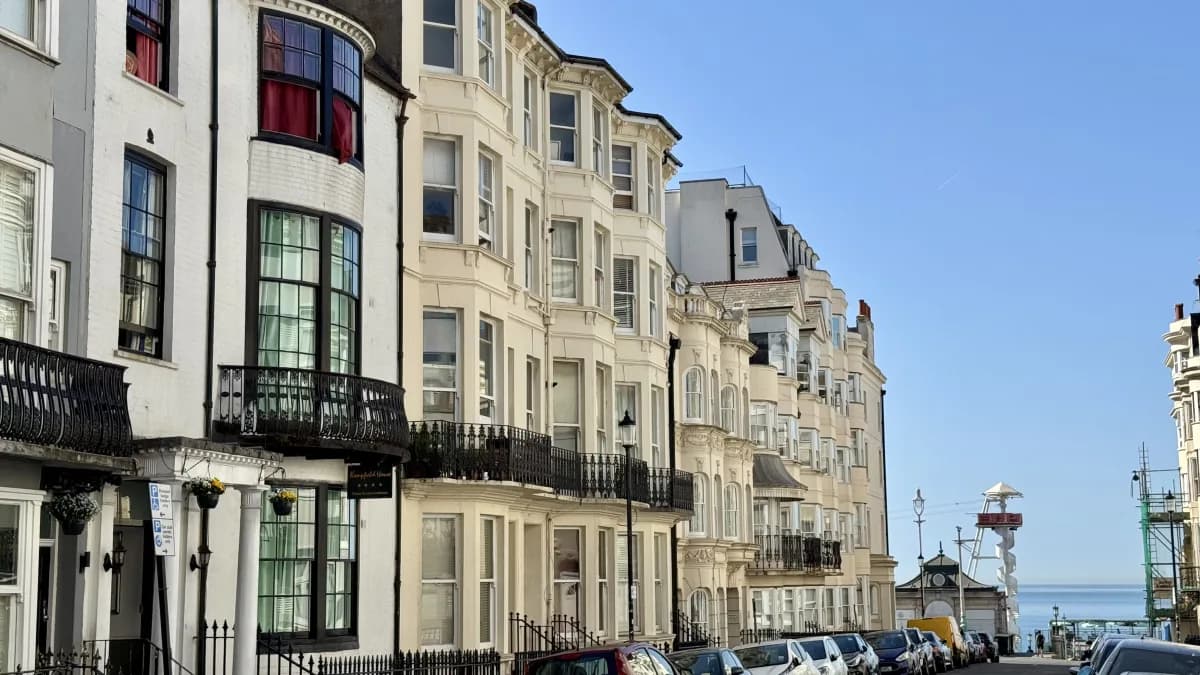 Cream Regency terraces with iron balconies sloping down towards the seafront