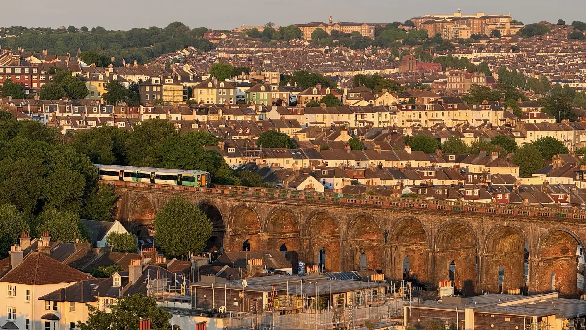 The London Road railway viaduct catching the last light of the day above Brighton's terraced rooftops