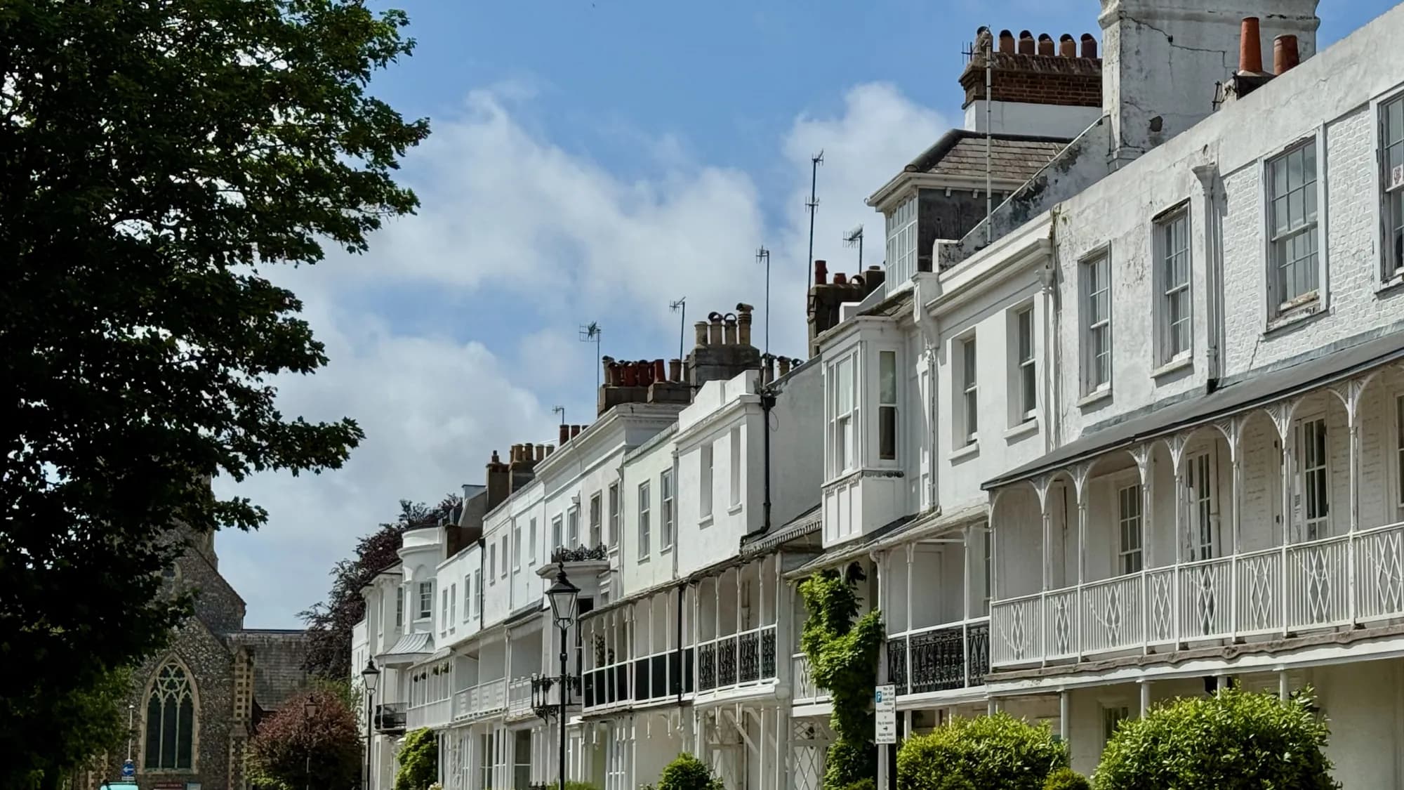 Ornate white cast-iron balconies on a Regency terrace in the town centre